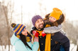 © deagreez - Photo of cheerful family mommy daddy daughter piggyback happy positive smile look each other winter trip outdoors