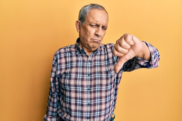 Canvas Print - Handsome senior man with grey hair wearing casual shirt looking unhappy and angry showing rejection and negative with thumbs down gesture. bad expression.