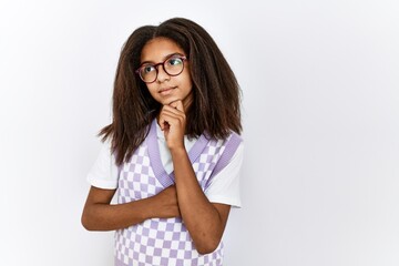 Sticker - Young african american girl standing over isolated background serious face thinking about question with hand on chin, thoughtful about confusing idea