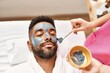 © Krakenimages.com - Man reciving facial treatment at beauty center.
