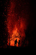 © ADDICTIVE STOCK - Silhouette of a couple against exploding lava in La Palma Canary Islands 2021