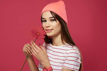 Wall Mural - pretty brunette wearing pink hat flower posing isolated background