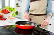 © deagreez - Cropped photo of charming attractive positive woman season food pepper pan smile indoors inside house home kitchen