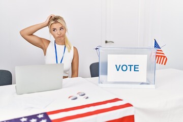 Wall Mural - Young caucasian woman at america political campaign election confuse and wondering about question. uncertain with doubt, thinking with hand on head. pensive concept.
