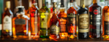 Beautiful Bokeh From A Row Of Alcoholic Bottles In Backlight.