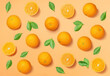 Fruit pattern arranged of oranges and orange leaves on yellow background. Lay out background.