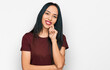 © Krakenimages.com - Young hispanic girl wearing casual t shirt looking confident at the camera with smile with crossed arms and hand raised on chin. thinking positive.