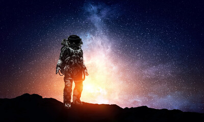 Wall Mural - astronaut walking on an unexplored planet