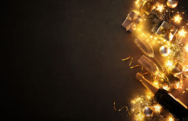 Wall Mural - New Years Eve holiday background with fir branches, champagne bottle, christmas balls, gift box and lights