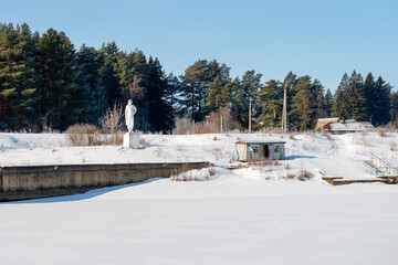 Wall Mural - Genre sculpture Komsomol girl (1937) installed on the barrier gate No. 103 of the Moscow channel, the village of Orevo, Dmitrovsky district of the Moscow region, Russia