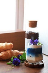 Poster - Ice milk tea butterfly pea fresh healthy drink in coffee shop, sweet drink in summer