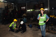 © ฺฺฺBoonterm - Female worker using a radio communicates to the factory guards for help to assist the injured engineer from the accident to take care of the initial symptoms : Worker accident insurance concept.