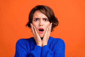 Sticker - Portrait of attractive worried depressed girl bad negative sudden news reaction isolated over vibrant orange color background