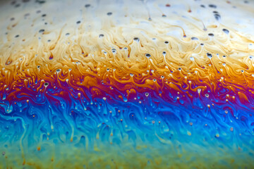 Wall Mural - macro picture of half soap bubble psychedelic color on black background
