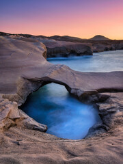 Wall Mural - sarakiniko beach. milos island. greece. a seascape during sunset. long exposure. rocks on the seasho
