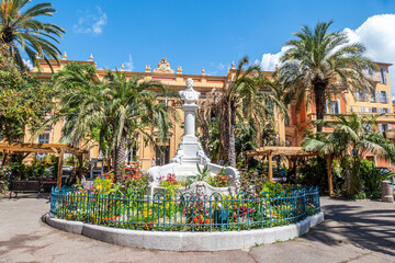 Wall Mural - Beautiful garden in Menton with the railway station in background