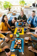 © Xavier Lorenzo - Group of young people having fun drinking on a rooftop terrace of a restaurant - Millennial friends celebrating together while having breakfast - Vertical image