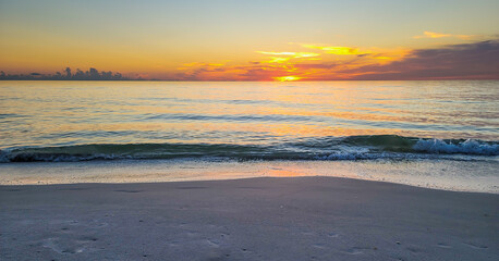 Fototapete - Small waves rolling inshore at sunset in Florida Naples Florida Beaches