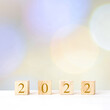 © mangpor2004 - Happy New Year 2022 on wood cube block and blur abstract bokeh light background with copy space for text, Happy new year 2022 greeting card, banner