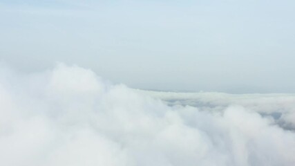 Wall Mural - View from above, drone point of view, stunning aerial video of a drone flying over some fluffy moving clouds. Copy space, natural background, video transition.