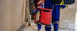 Selective focus automated external defibrillator (AED) on hand of paramedic staff on web banner resolution. Emergency team service.
