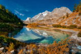 Fototapeta Na ścianę - Autumn colors in the wild Val Veny with lake in foreground, Aosta Valley, Italy