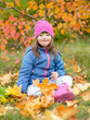 © Ermolaev Alexandr - Happy young girl with down syndrome sitting on autumn leaves