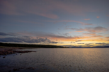  The view on the beech of the Bottenhavet inlet in Sweden. Made with setting sun towards the main land of Sweden.