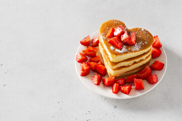 Stack of heart pancake with strawberry on white background