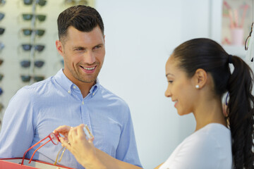 Wall Mural - attractive woman testing new glasses with optician