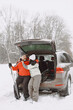 © prostooleh - Senior couple sitting in a car trunk in a forest