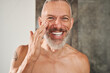 © Yakobchuk Olena - Mature man applying anti-aging cream on his face