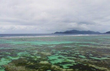 Top view of a beautiful emerald beach with corals in the Seychelles