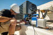 © spatesphoto - HVAC technician repairing an air conditioner
