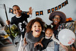 © Seventyfour - POV shot of excited African-American kids wearing Halloween costumes at home and looking at camera