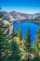 Wall Mural - blue lake in the mountains with large volcanic cinder cone island.