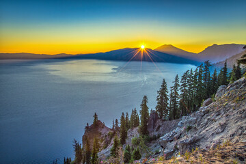 Wall Mural - sunrise over a large mountain lake on a clear summer morning.