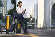 © imtmphoto - young asian business man standing on street looking at mobile phone