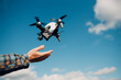 Man pilot Launches quadcopter drone from hand to sky flight