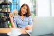 © Mallika - Happy woman with laptop and holding dollars bank notes