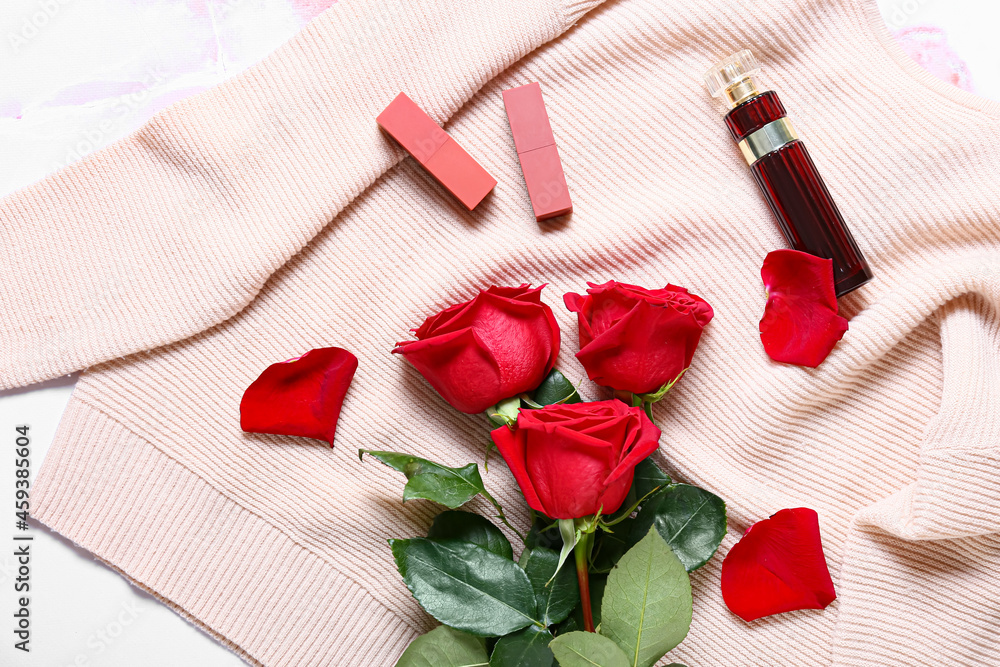 Beautiful roses and stylish female accessories on light table, closeup