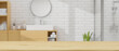 Mockup space on wooden tabletop over blurry modern Scandinavian bathroom interior