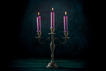 Burning Candles In A Vintage Candle Holder On A Dark Background