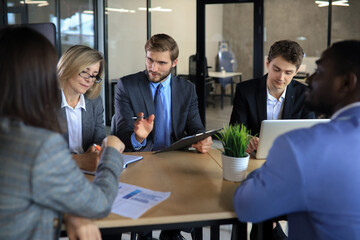 Poster - Business meeting - manager discussing work with his colleagues.