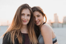 Smiling Woman Leaning On Female Friend