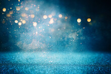 Background Of Abstract Glitter Lights. Gold, Blue And Black. De Focused