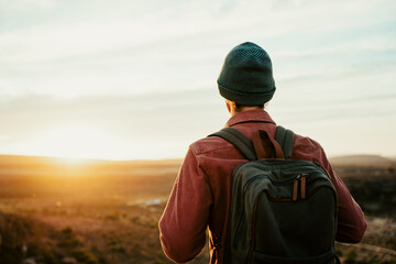 caucasian male free spirit walking through wilderness watching sunset