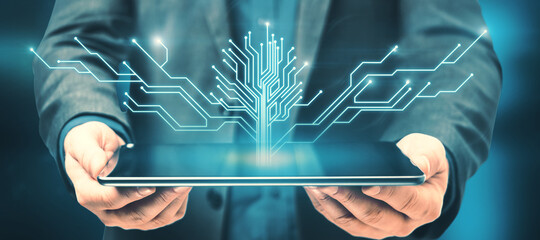 Canvas Print - Close up of hand holding tablet computer with abstract digital circuit tree on blurry blue background. Information, technology and business concept.