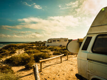 Camper Van With Surf Board On Beach