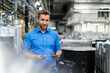 © Westend61 - Male business professional with digital tablet at factory